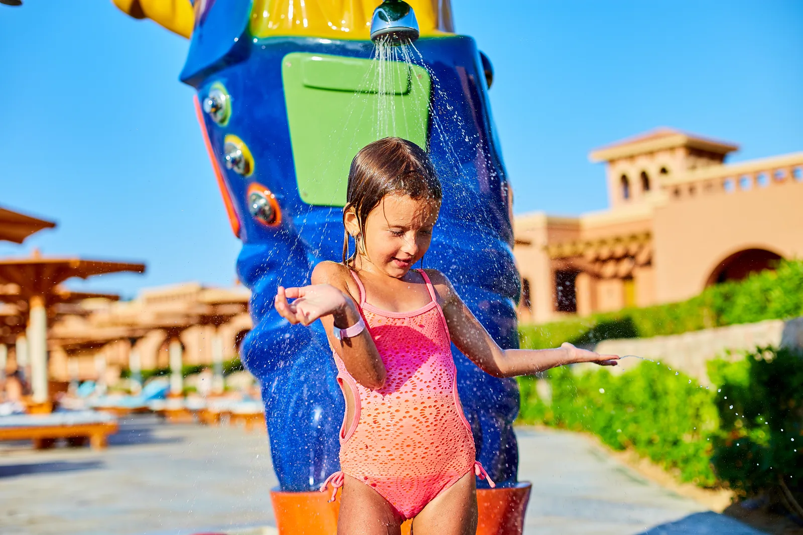 Child playing in a colorful resort water park