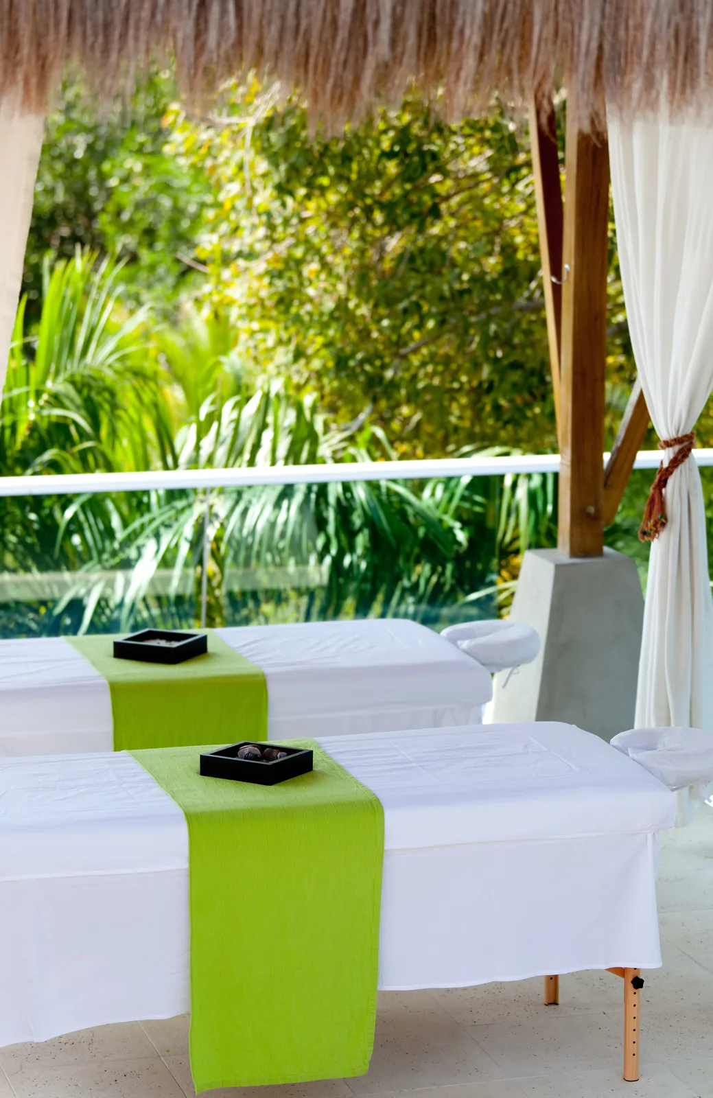 Spa treatment tables in a tropical setting